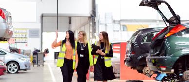 GTG Health and Safety advisors and client wearing hi-vis walking through workshop