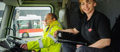 female apprentice sitting in GTG truck beside instructor