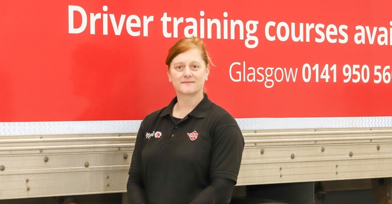 woman standing beside a GTG truck