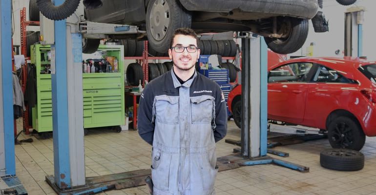 GTG Apprentice Harry in front of car ramp 