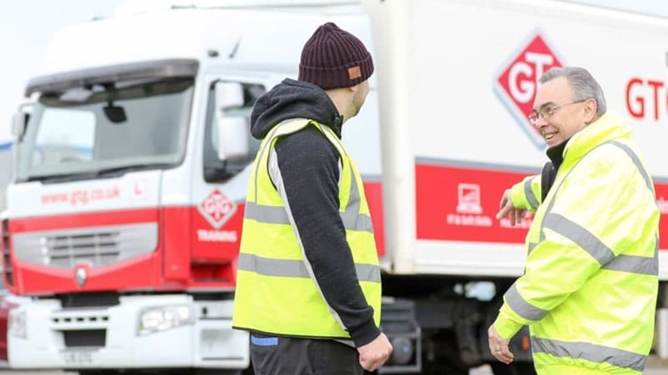 two men in front of GTG training lorry
