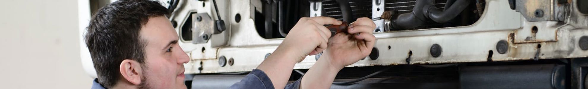 HGV apprentice working on vehicle