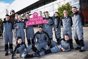 12 GTG Princes Trust apprentices holding a pink 'Youth Can Do It' sign
