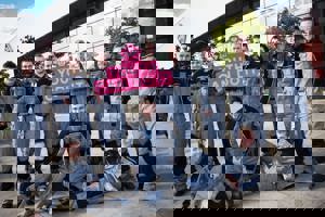 12 GTG Princes Trust apprentices holding a pink 'Youth Can Do It' sign