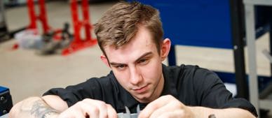 apprentice working on engine