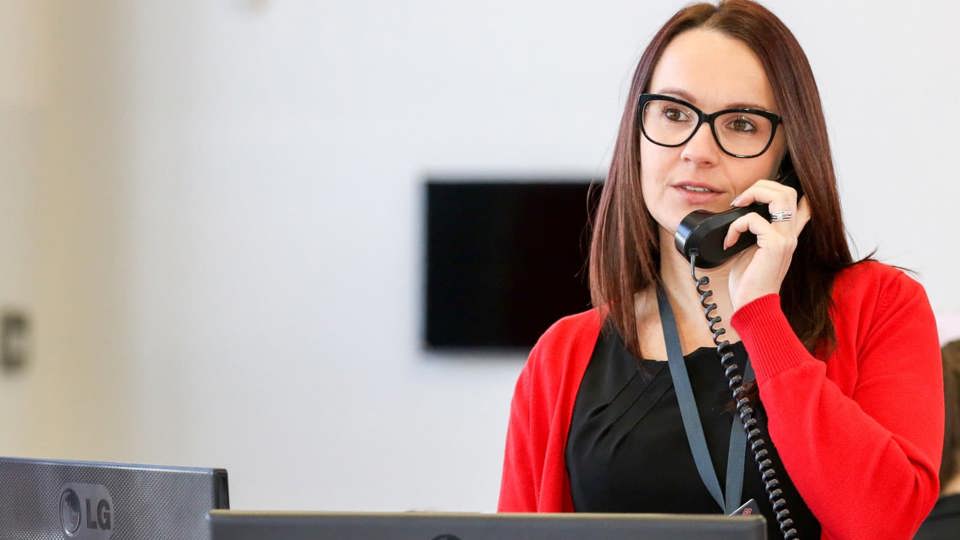 woman talking on a phone in an office